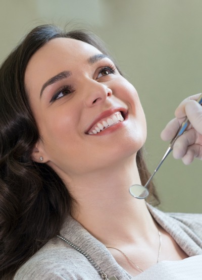 Woman receiving oral cancer screenings