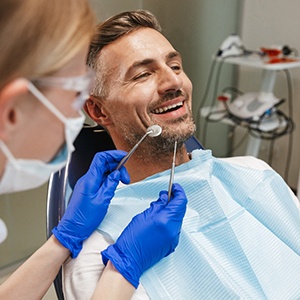 man smiling while getting dental implants in Conroe 